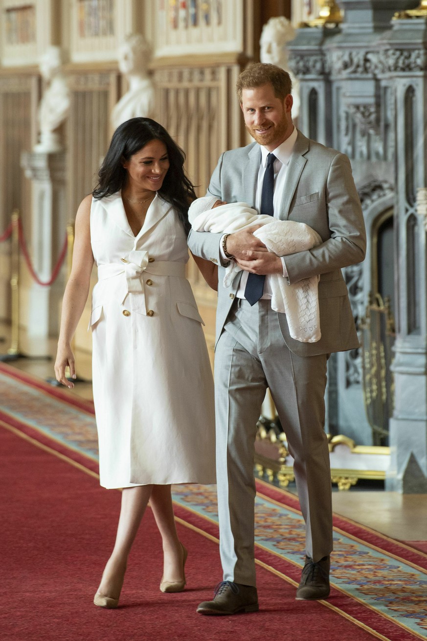 Britain&#039;s Prince Harry and Meghan, Duchess of Sussex, arrive for a photocall with their newborn son, in St George&#039;s Hall at Windsor Castle, Windsor, south England, Wednesday May 8, 2019. Bab ...