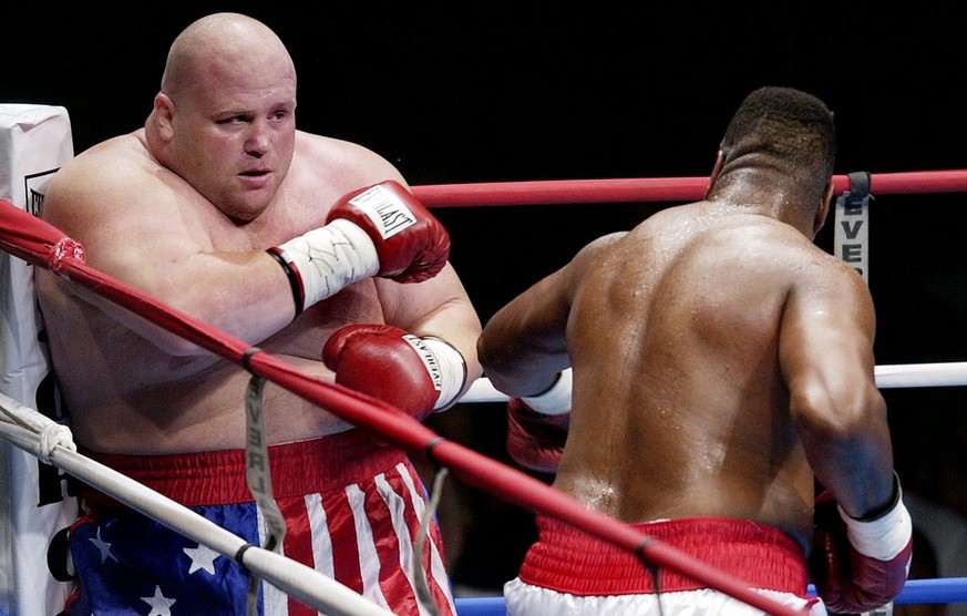 Eric &quot;Butterbean&quot; Esch, left, is backed into a corner by Larry Holmes, right, Saturday night, July 27, 2002, at the Norfolk Scope in Norfolk, VA. (AP Photo/Gary C. Knapp)