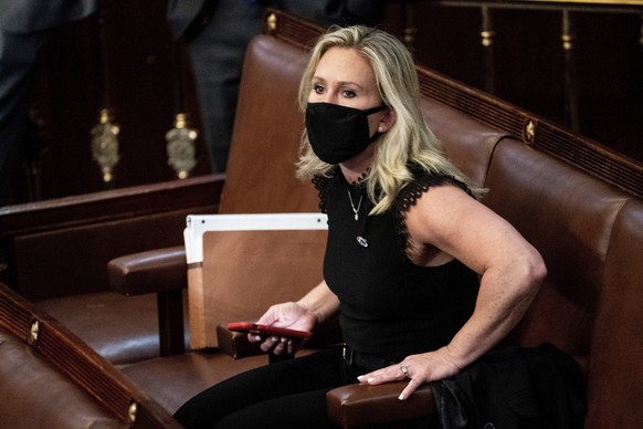 FILE - In this Jan. 6, 2021, file photo, Rep. Marjorie Taylor Greene, R-Ga., sits in the House Chamber after they reconvened for arguments over the objection of certifying Arizona&#039;s Electoral Col ...
