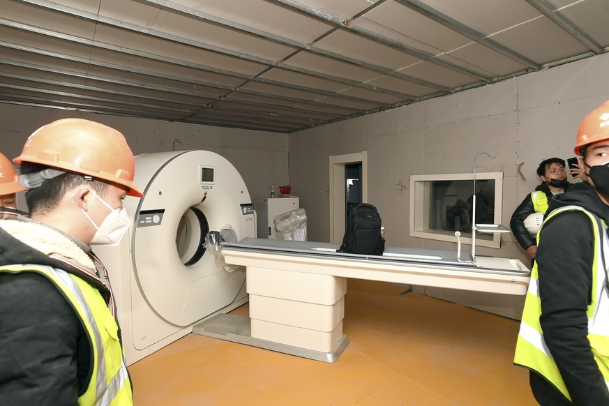 People walk near a CT scanner in a room at the Huoshenshan temporary field hospital in Wuhan in central China&#039;s Hubei Province, Sunday, Feb. 2, 2020. The Philippines on Sunday reported the first  ...