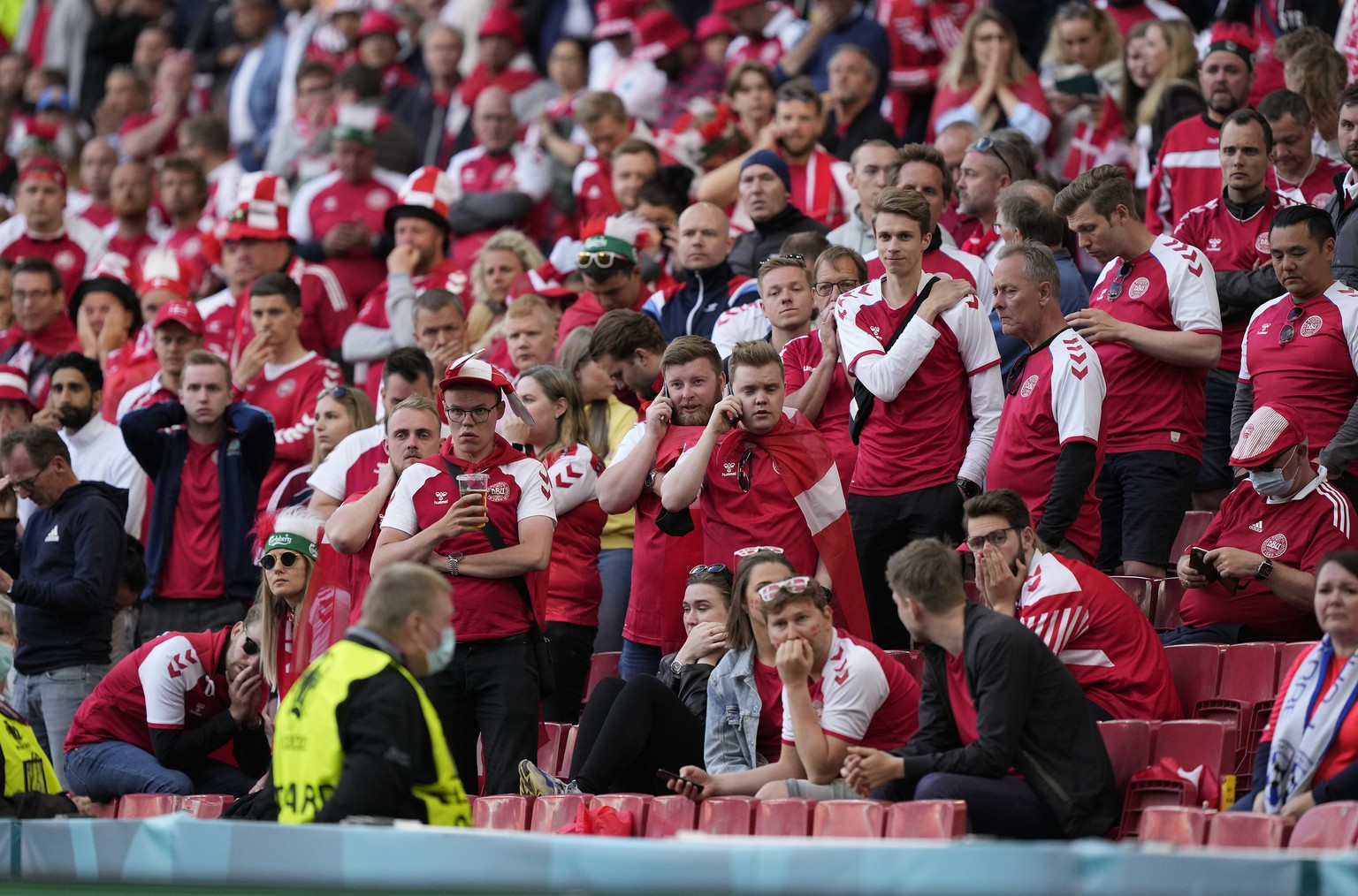 epa09265377 Denmark fans react while Christian Eriksen (not seen) of Denmark receives medical assistance during the UEFA EURO 2020 group B preliminary round soccer match between Denmark and Finland in ...