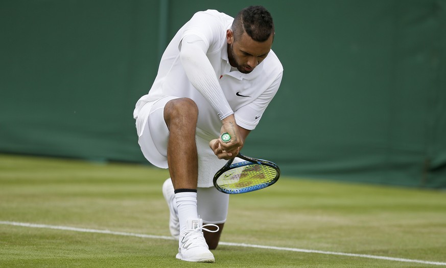 Australia&#039;s Nick Kyrgios mimics a cricket shot after winning a point against Australia&#039;s Jordan Thompson in a Men&#039;s singles match during day two of the Wimbledon Tennis Championships in ...