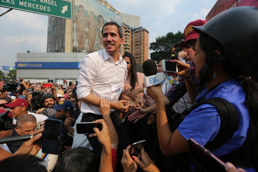 Venezuela&#039;s opposition leader and self proclaimed president Juan Guaido, greets the crowd from the door of a vehicle during a rally in Maracay, Venezuela, Friday, April 26, 2019. The Trump admini ...