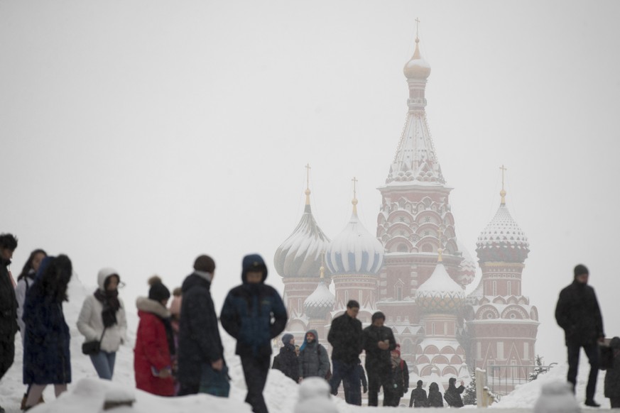 People walk in snow in Moscow&#039;s Red Square, with the St. Basil&#039;s Cathedral in the background Russia, Wednesday, Jan. 31, 2018. According to forecasts snowfalls and blizzard will continue in  ...