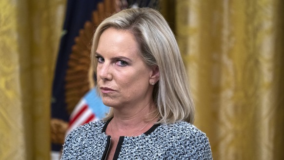 epa07491144 (FILE) US Secretary of Homeland Security Kirstjen Nielsen listens to Vice President Mike Pence speak at an event to honor federal immigration agents in the East Room of the White House in  ...