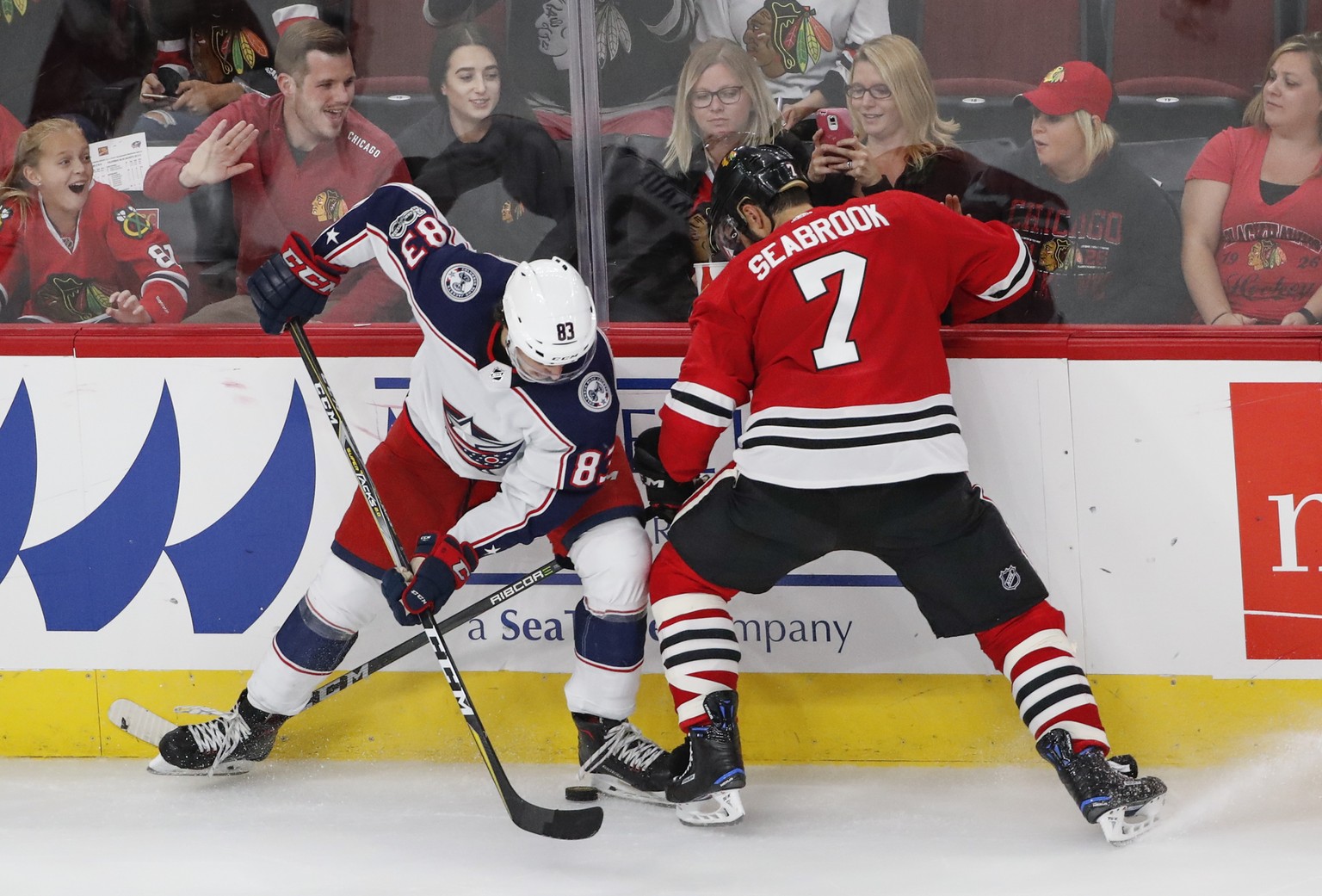 Columbus Blue Jackets center Calvin Thurkauf (83) battles for the puck with Chicago Blackhawks defenseman Brent Seabrook (7) during the third period of a preseason NHL hockey game Saturday, Sept. 23,  ...