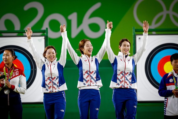epa05463407 Korea&#039;s Chang Hyejin (L-R), Choi Misun, and Ki Bobae acknowledge the crown from the podium after they were introduced as the gold medal winners in the women&#039;s team competition of ...