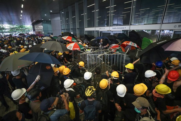 epa07686881 Protesters try to break into the Legislative Council building during the annual 01 July pro-democracy march in Hong Kong, China, 01 July 2019. Protesters are demanding the resignation of H ...
