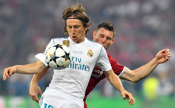 epa06765453 Real Madrid&#039;s Luka Modric (front) and James Milner of Liverpool FC in action during the UEFA Champions League final between Real Madrid and Liverpool FC at the NSC Olimpiyskiy stadium ...