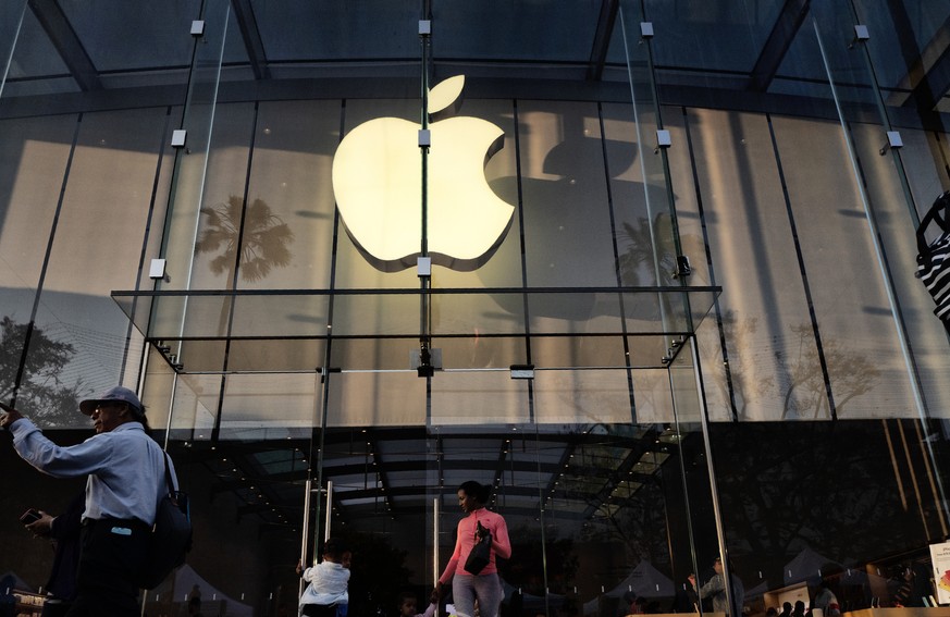 FILE - In this June 15, 2019, file photo customers leave an Apple store on the 3rd Street Promenade in Santa Monica, Calif. Big Tech companies reported mixed quarterly earnings on Thursday, July 30, 2 ...