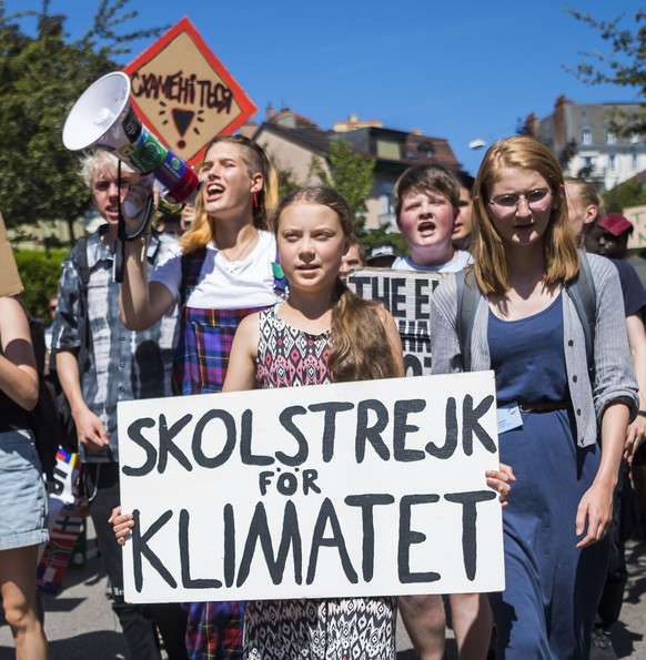 Swedish climate activist Greta Thunberg reacts with other young climate activists during a demonstration against climate change on the closing day of the «&#039; Smile for Future Summit for climate&#0 ...
