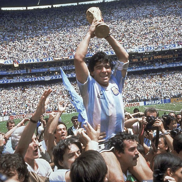 FILE - In this June 29, 1986 file photo, Diego Maradona holds up his team&#039;s trophy after Argentina&#039;s 3-2 victory over West Germany at the World Cup final soccer match at Azteca Stadium in Me ...