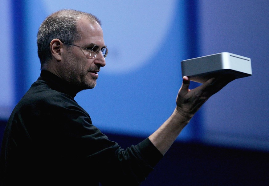 SAN FRANCISCO - JANUARY 11: Apple CEO Steve Jobs holds the new Mac Mini personal computer during his keynote address at the 2005 Macworld Expo January 11, 2005 in San Francisco, California. Jobs annou ...