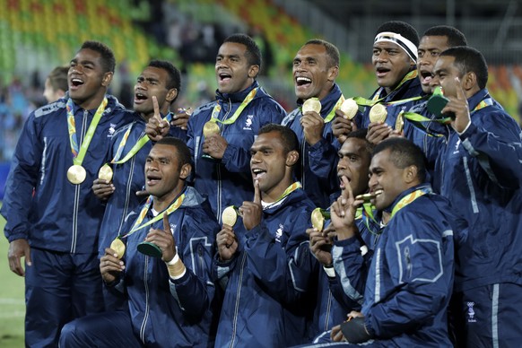 Fiji rugby players show off their gold medal after defeating Britain in mens rugby sevens at the 2016 Summer Olympics in Rio de Janeiro, Brazil, Thursday, Aug. 11, 2016. (AP Photo/Robert F. Bukaty)