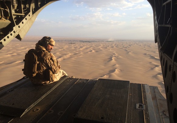 FILE - In this Sept. 17, 2015 photo, an Emirati gunner watches for enemy fire from the rear gate of a United Arab Emirates Chinook military helicopter flying over Yemen. The United Arab Emirates flatl ...
