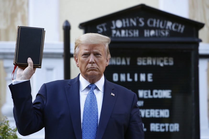 President Donald Trump holds a Bible as he visits outside St. John&#039;s Church across Lafayette Park from the White House Monday, June 1, 2020, in Washington. Part of the church was set on fire duri ...