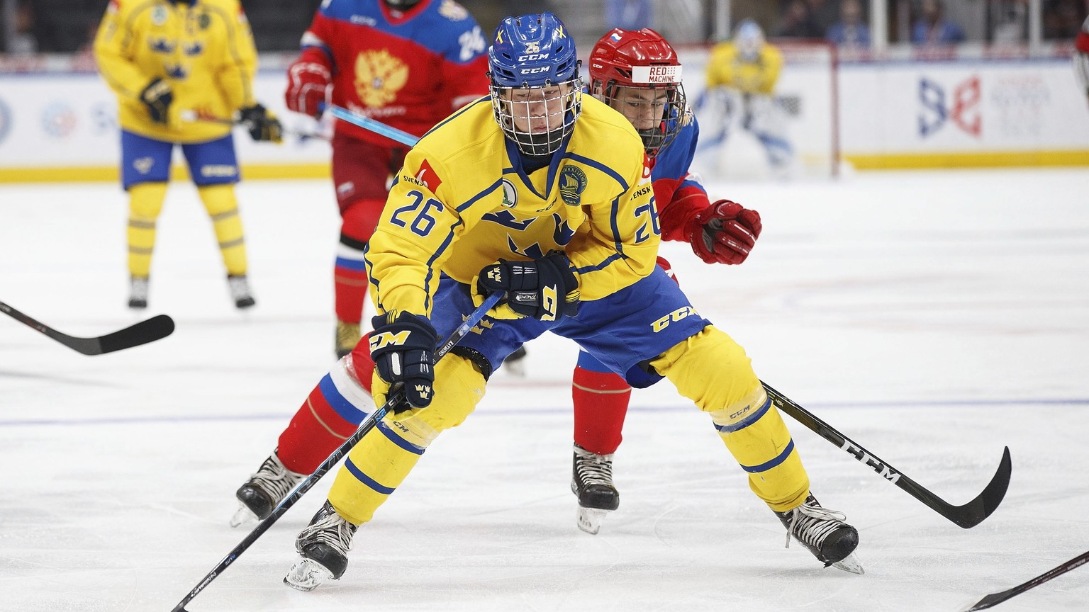 Russia&#039;s Yegor Chinakhov (26) pursues Sweden&#039;s Lucas Raymond (26) during the first period of a Hlinka Gretzky Cup hockey game in Edmonton, Alberta, Wednesday, Aug. 8, 2018. (Codie McLachlan/ ...
