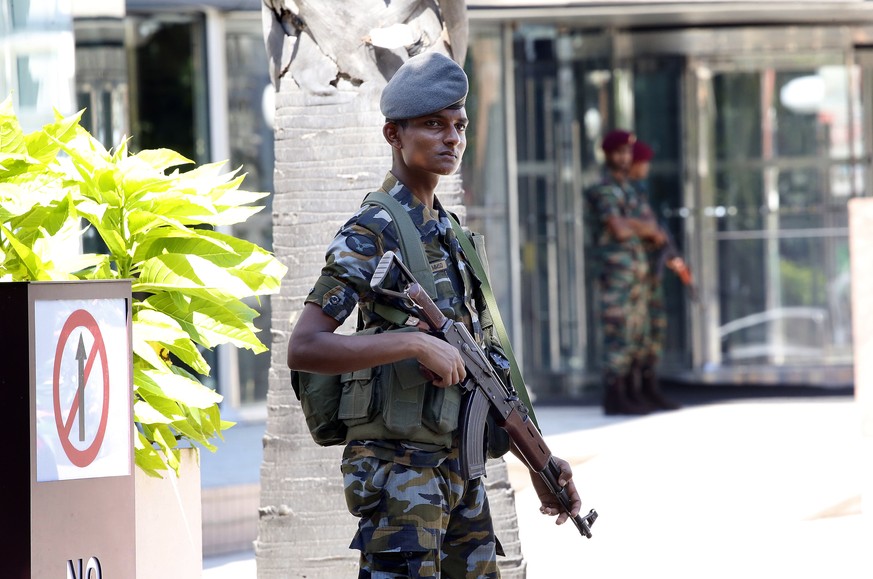 epa07520996 Sri Lankan Security personel stand guard outside the World Trade Centre, the day after multiple fatal explotisions occured the day before, in Colombo, Sri Lanka, 22 April 2019. According t ...