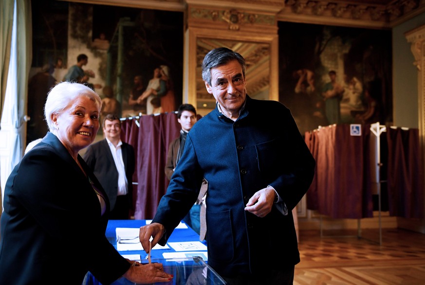 French politician Francois Fillon, member of the conservative Les Republicains political party, casts his ballot during the second round of the French center-right presidential primary election in Par ...