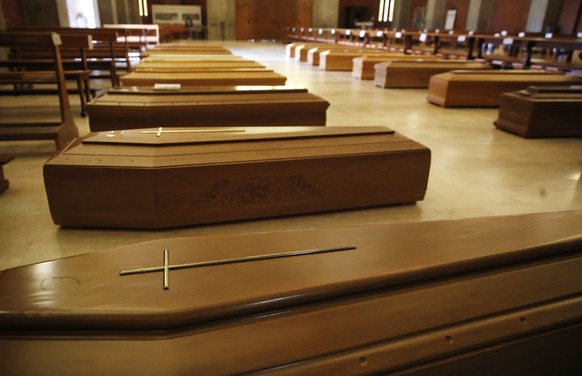 Coffins are lined up on the floor in the San Giuseppe church in Seriate, one of the areas worst hit by coronavirus, near Bergamo, Italy, waiting to be taken to a crematory, Thursday, March 26, 2020. T ...