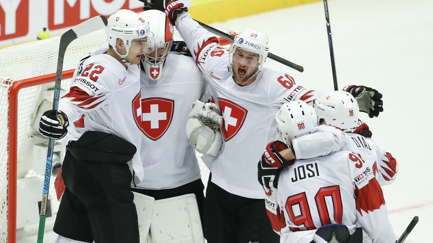 Players of Switzerland celebrate after the Ice Hockey World Championships quarterfinal match between Finland and Switzerland at the Jyske Bank Boxen arena in Herning, Denmark, Thursday, May 17, 2018.  ...