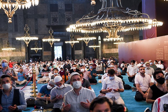 Muslims, wearing protective masks as a precaution against infection from coronavirus gather for the Eid al-Adha prayer inside the Byzantine-era Hagia Sophia, recently converted back to a mosque, in th ...
