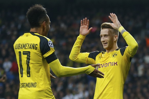 Dortmund&#039;s Marco Reus, right, celebrates with Pierre-Emerick Aubameyang after scoring his side&#039;s 2nd goal during the Champions League, Group F, soccer match between Real Madrid and Borrusia  ...