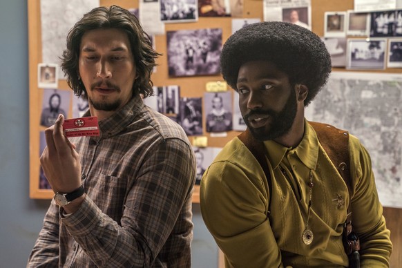 This image released by Focus Features shows Adam Driver, left, and John David Washington in a scene from &quot;BlacKkKlansman.&quot; The cast was nominated for a SAG Award for best ensemble. The SAG A ...
