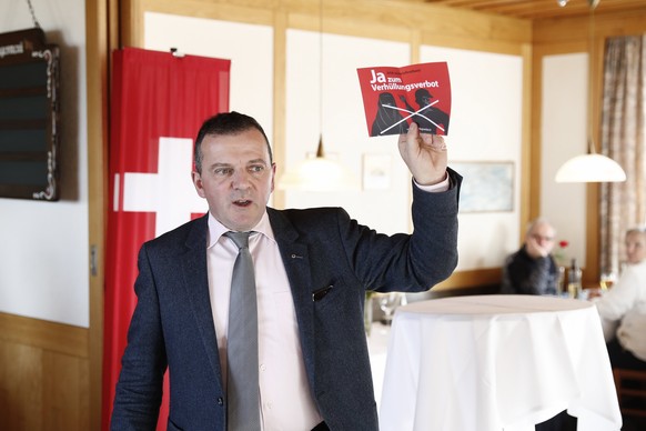 epa05787685 Walter Wobmann, National Councillor, shows a leaflet with the titel &#039;Yes to the ban of veiling&#039;, during the reunion of the Swiss People&#039;s Party SVP in Dornach, Switzerland,  ...