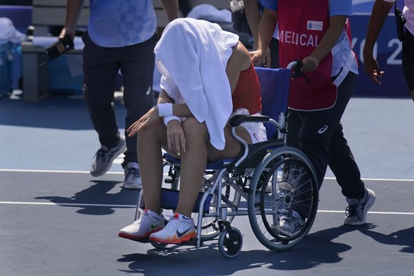 Paula Badosa, of Spain, is helped off the court in a wheelchair after retiring due to illness during the quarterfinals of the tennis competition at the 2020 Summer Olympics, Wednesday, July 28, 2021,  ...
