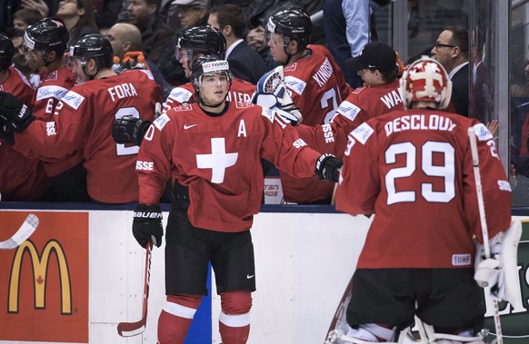 Switzerland forward Kevin Fiala, left, celebrates his first-period goal against Denmark with goaltender Gauthier Descloux, during the first period of a round-robin game at the hockey World Junior Cham ...