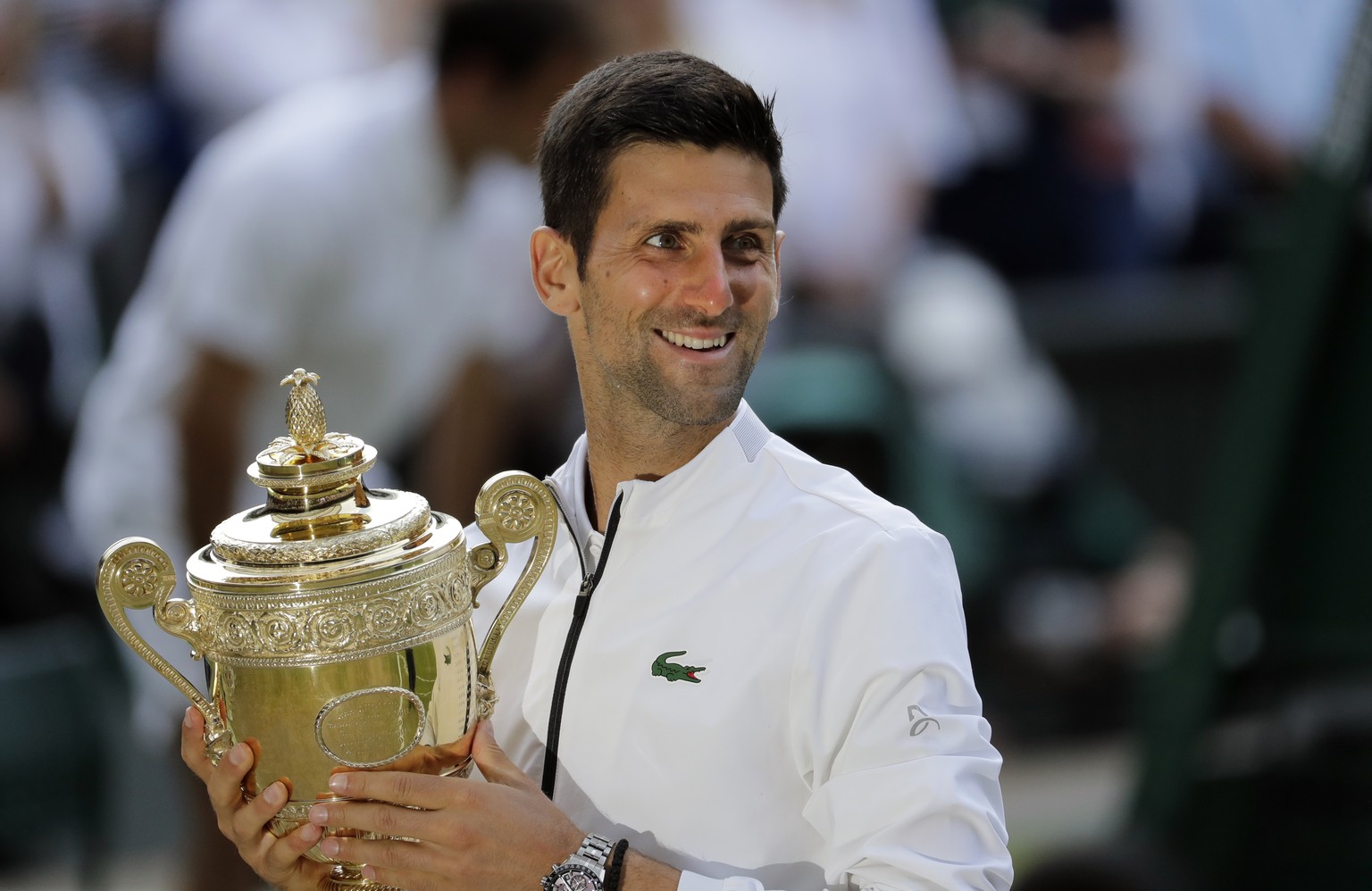 Serbia&#039;s Novak Djokovic holds his trophy after defeating Switzerland&#039;s Roger Federer during the men&#039;s singles final match of the Wimbledon Tennis Championships in London, Sunday, July 1 ...