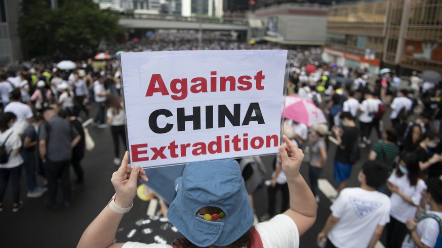 epa07642808 Protesters hold placards during a rally against an extradition bill outside the Legislative Council in Hong Kong, China, 12 June 2019. The bill, scheduled for a second reading on 12 June h ...