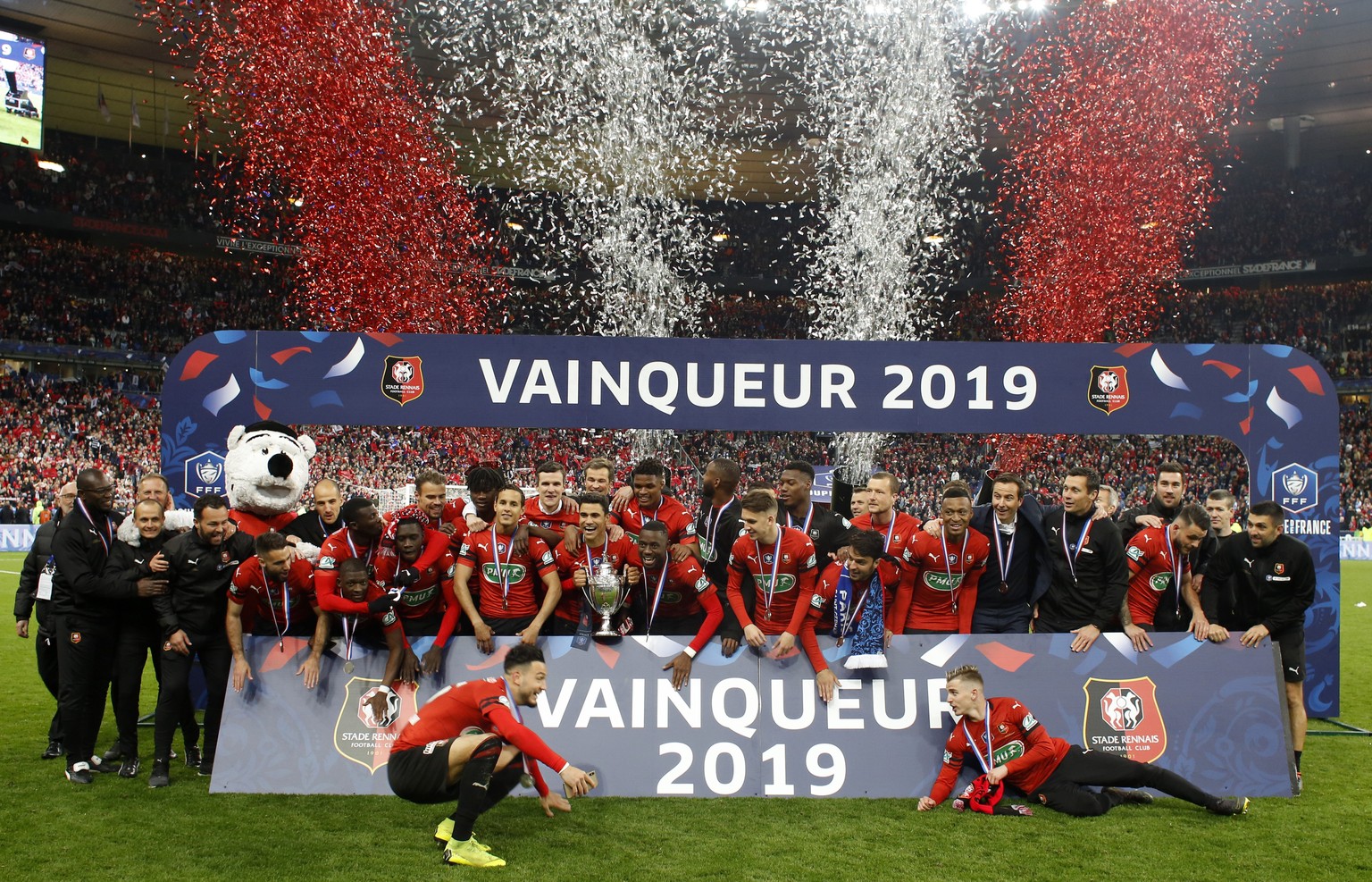 Team of Rennes celebrate with trophy after winning the French Cup soccer final between Rennes and Paris Saint Germain at the Stade de France stadium in Saint-Denis, outside Paris, France, Saturday, Ap ...