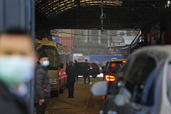 A convoy of vehicles carrying the World Health Organization team enters the interior of the Huanan Seafood Market on the third day of field visit in Wuhan in central China&#039;s Hubei province on Sun ...