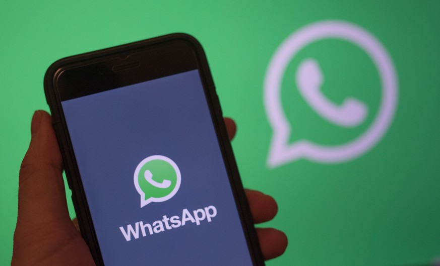 epa07568740 epa07306542 (FILE) - A smart phone screen shows the logo of WhatsApp application in Berlin, Germany, 31 December 2017 (reissued 14 May 2019). Facebook&#039;s messenger service WhatsApp has ...