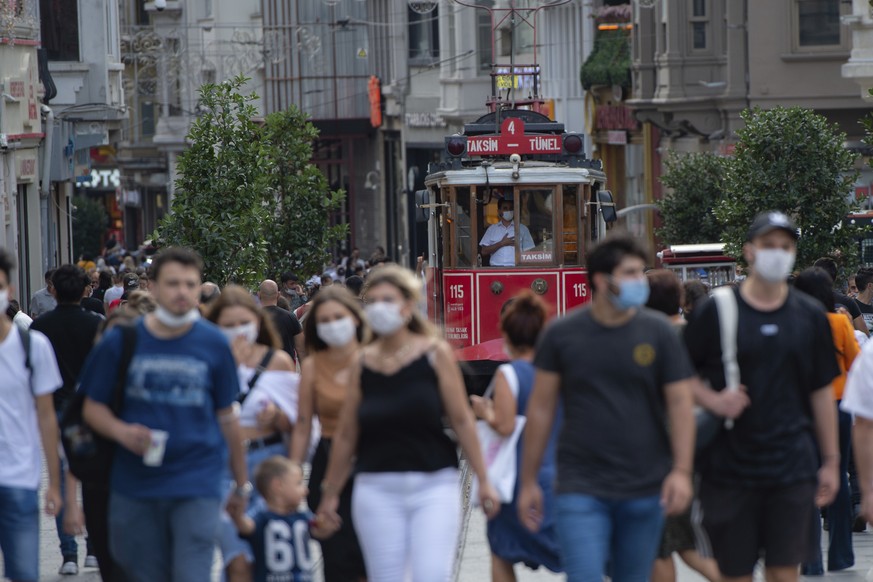 People wearing masks for protection against the spread of coronavirus, walk along Istiklal street, the main shopping street in Istanbul, Friday, Sept. 11, 2020. Turkey is getting tough on people who f ...