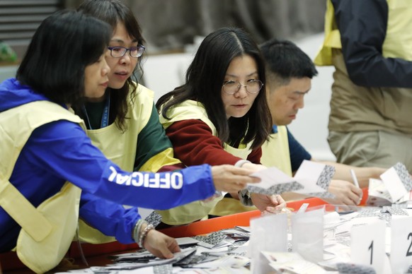 Election workers count ballots at a polling station in Hong Kong, Sunday, Nov. 24, 2019. Voters in Hong Kong turned out in droves on Sunday in district council elections seen as a barometer of public  ...