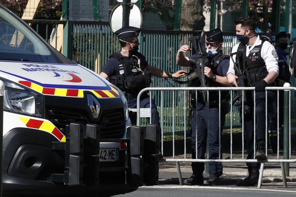 Police officers block the access with barriers next to the Police station in Rambouillet, south west of Paris, Friday, April 23, 2021. A French police officer was stabbed to death inside her police st ...