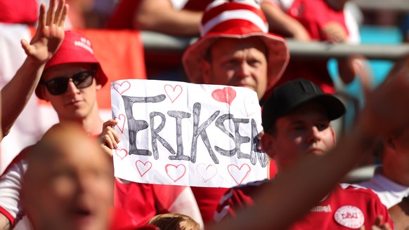 epa09280016 A fan of Denmark holds a sign dedicated to Danish soccer player Christian Eriksen prior to the UEFA EURO 2020 group B preliminary round soccer match between Denmark and Belgium in Copenhag ...