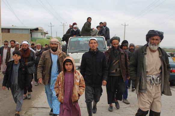 epa07458602 People carry the bodies (in truck) of the civilians who they claim have been killed by airstrikes in Kunduz, Afghanistan, 23 March 2019. At least 13 civilians including women and children  ...