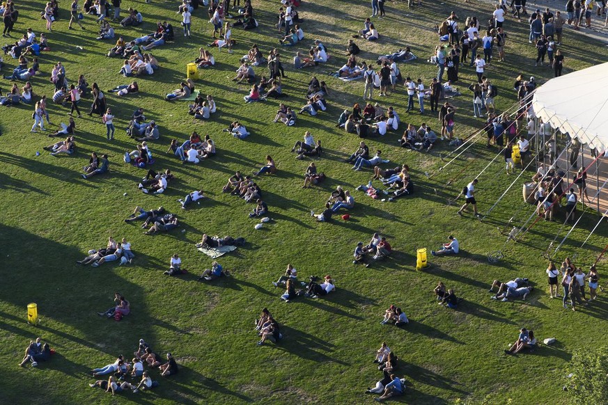 Festival goers relax in the grass, during the 35st of the Gurten music open air festival in Bern, Switzerland, this Wednesday, July 11, 2018. The open air music festival runs from 11 to 14 July.(KEYST ...