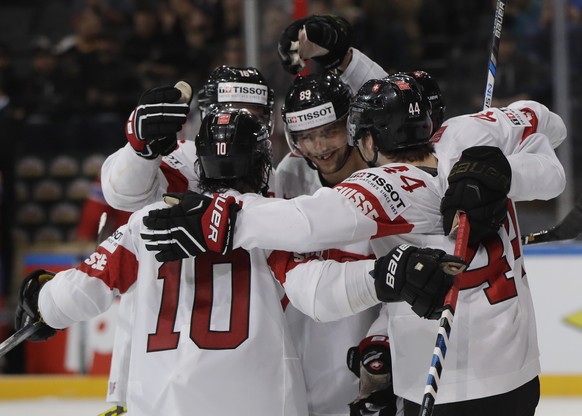 Switzerland&#039;s Pius Suter, right, celebrates with teammates scoring his sides third goal during the Ice Hockey World Championships group B match between Norway and Switzerland in the AccorHotels A ...