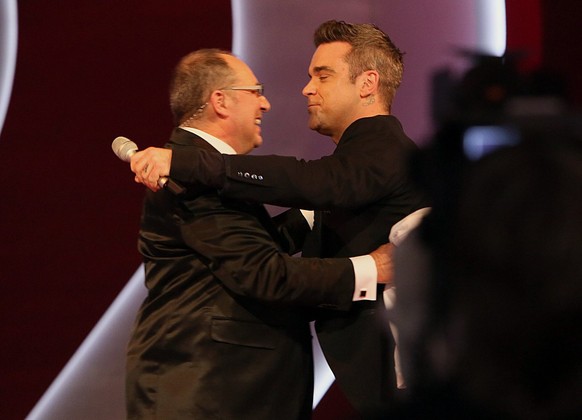 HANDOUT --- Moderator Bernard Thurnheer, links, wird vom britischen Saenger Robbie Williams, rechts, umarmt, anlaesslich seiner letzten &quot;Benissimo&quot;-Sendung, am Samstag, 1. Dezember 2012, in  ...