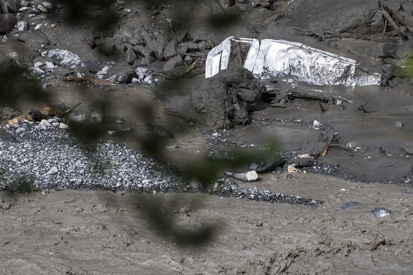 epa07770002 A view of the wreckage of a car washed away by a mudslide resting in the bed of the Losentse River in Chamoson, canton Valais, Switzerland, 12 August 2019. Search efforts continued on the  ...