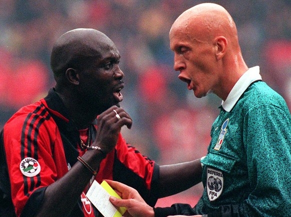 AC Milan Liberian-born striker George Weah argues with referee Pierluigi Collina, right, during the Italian first division match AC Milan vs Roma at the Milan San Siro stadium Sunday, October 25, 1998 ...