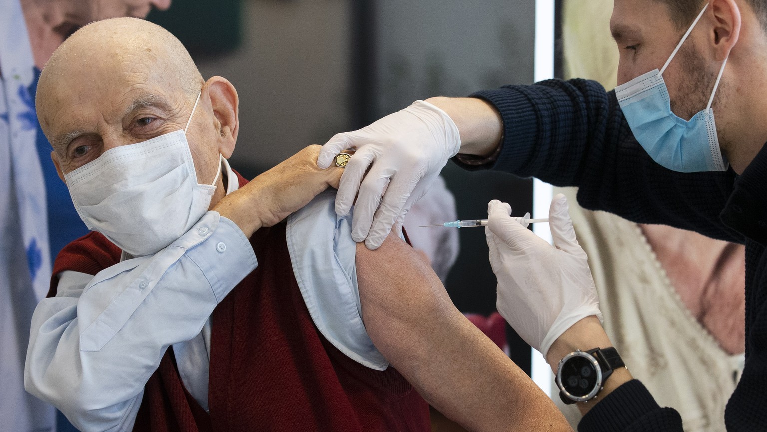 Fabien, nurse of IMAD, vaccinates Leon T. (alias name), 80, as he becomes the first person in Geneva to receive the Pfizer/BioNtech COVID-19 vaccine at the IEPA (Building with supervision for the elde ...