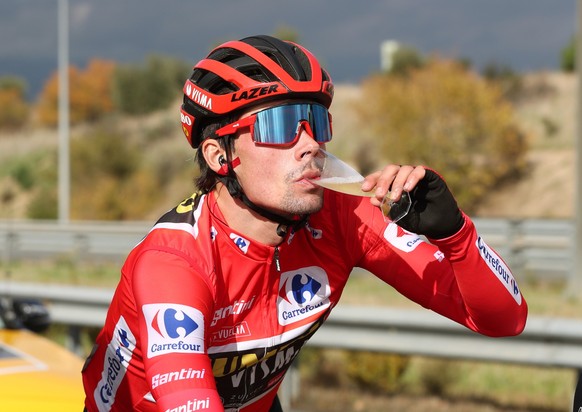 epa08807482 Slovenian rider Primoz Roglic (Jumbo Visma) drinks from a glass as he rides during the final stage of the Vuelta a Espana 2020 cycling race, over 139.6 km from Hipodromo de la Zarzuela to  ...