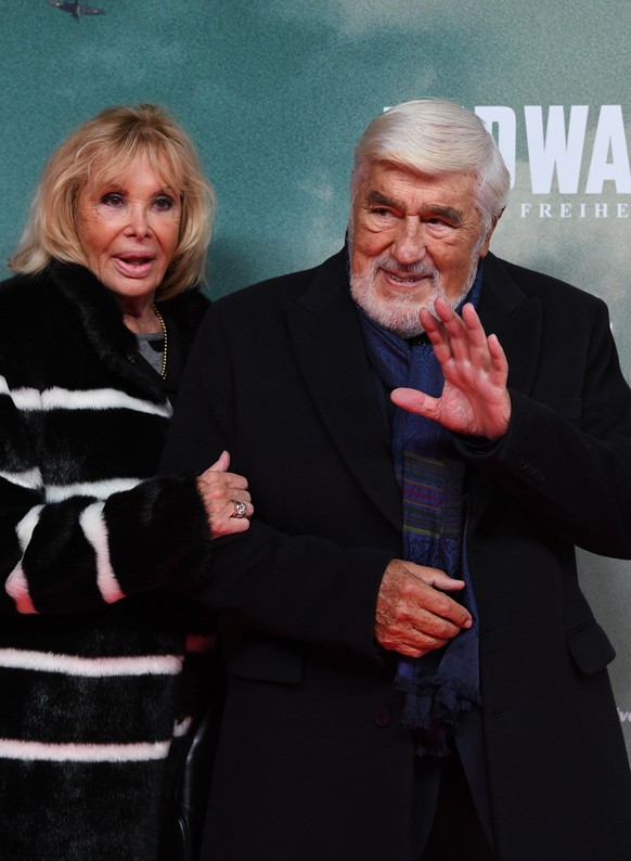 epa07947257 German actor Mario Adorf (R) and his wife Monique Faye arrive for the premiere of the film &#039;Midway&#039; in Munich, Germany, 24 October 2019. The movie opens across German theaters on ...