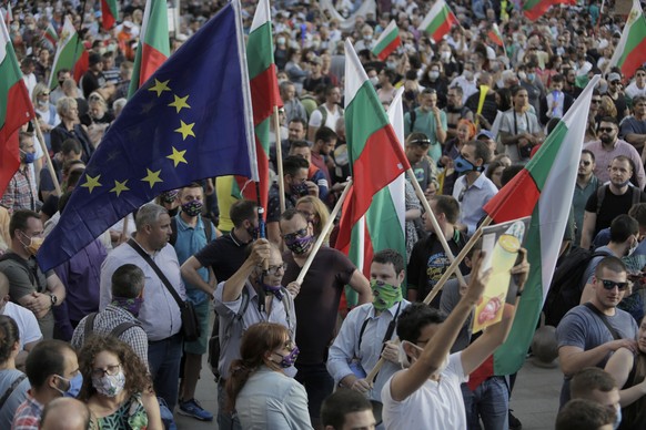 Protesters wave Bulgarian and EU flags as they take part in anti-governmental protest in downtown Sofia on Monday, July 13, 2020. Thousands of mostly young Bulgarians took to the streets on Monday to  ...